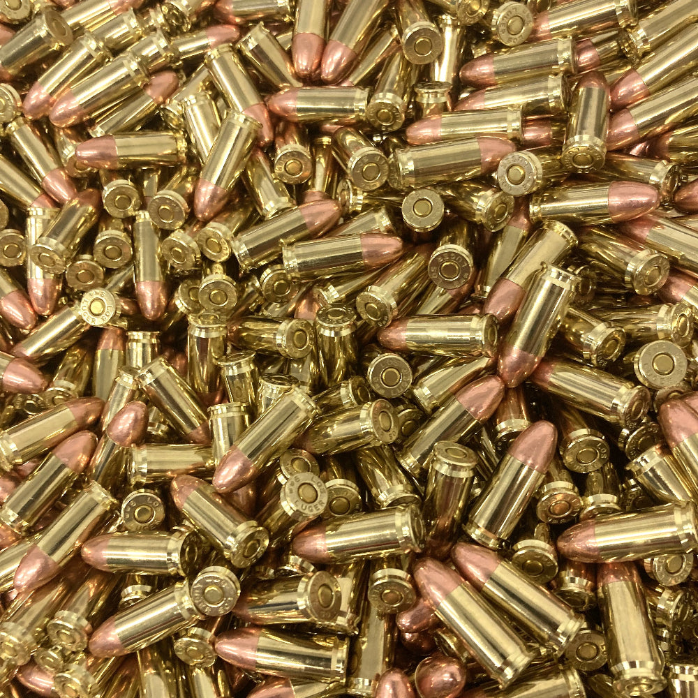 Close-up of a large pile of brass pistol bullets.