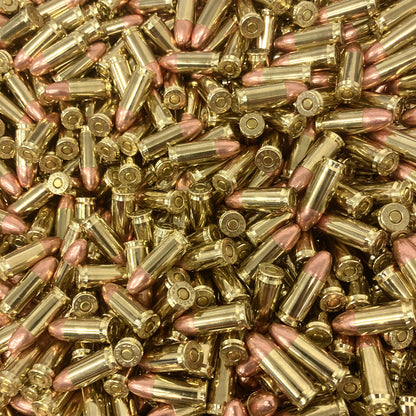 Close-up of a large pile of brass pistol bullets.